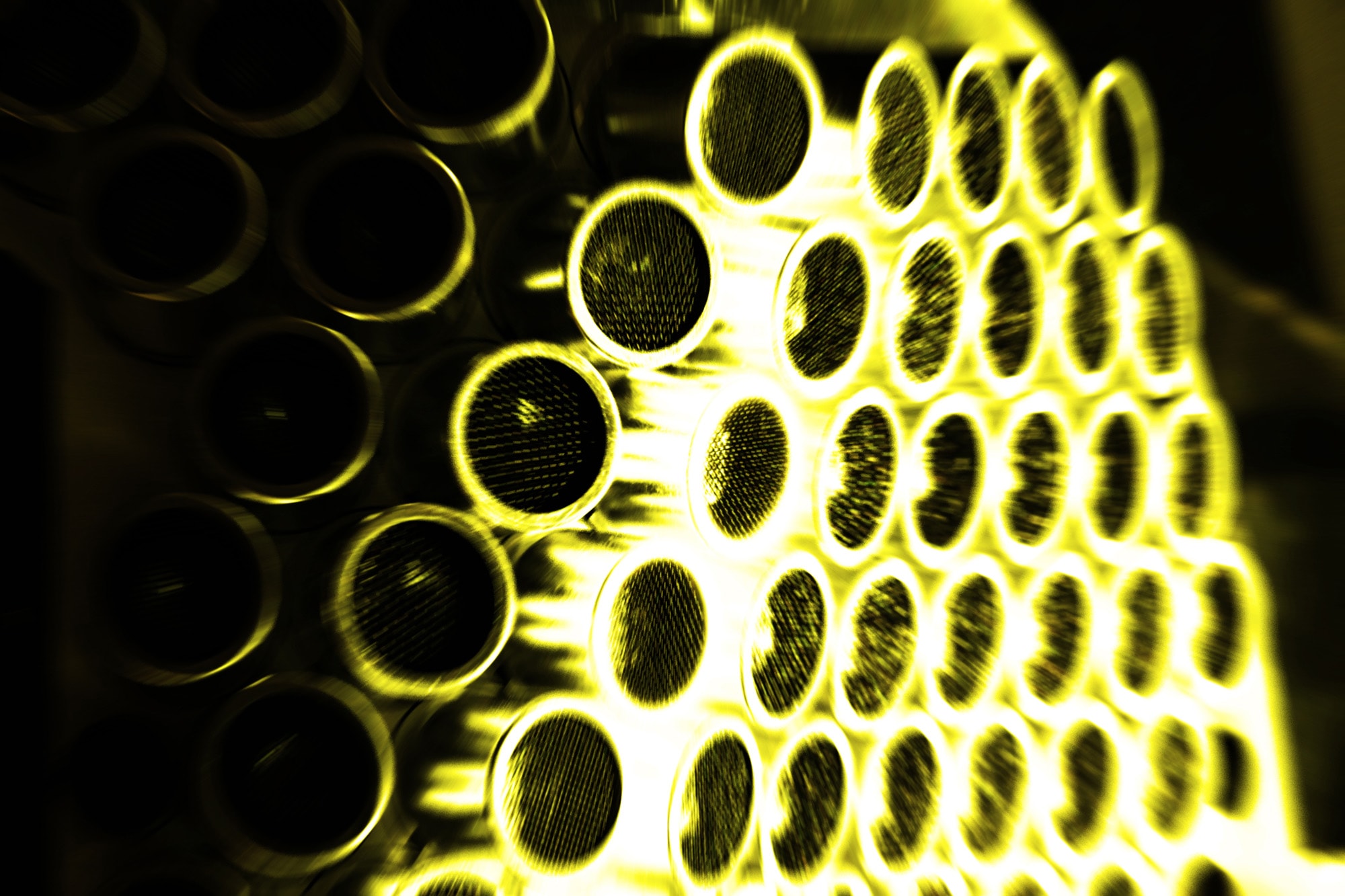 close up of a sculpture, circles with metal mesh, yellowish cat to the photograph
