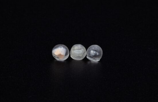 three spheres containing something unknown inside on a black background
