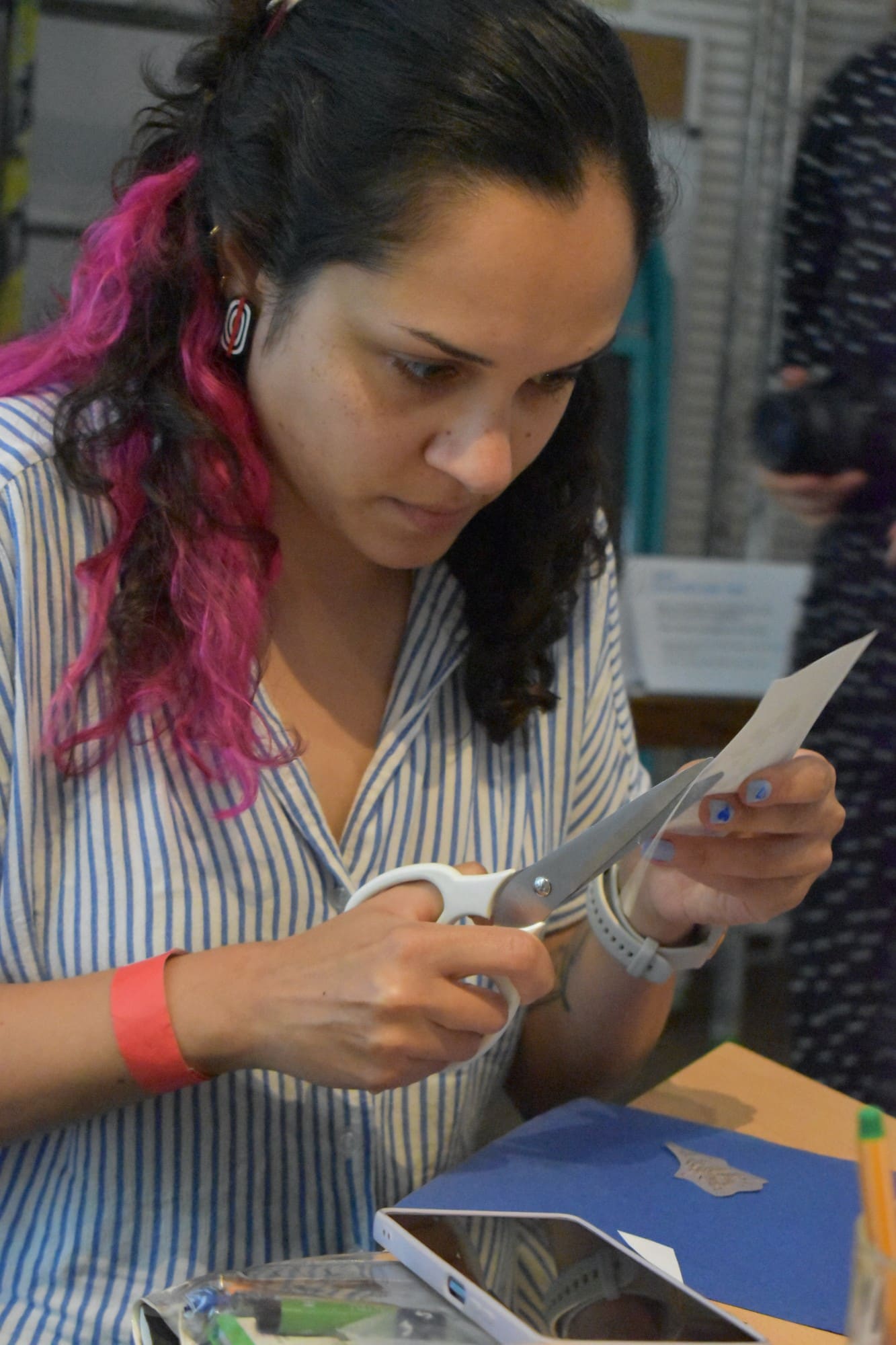 a woman cutting paper with scissors