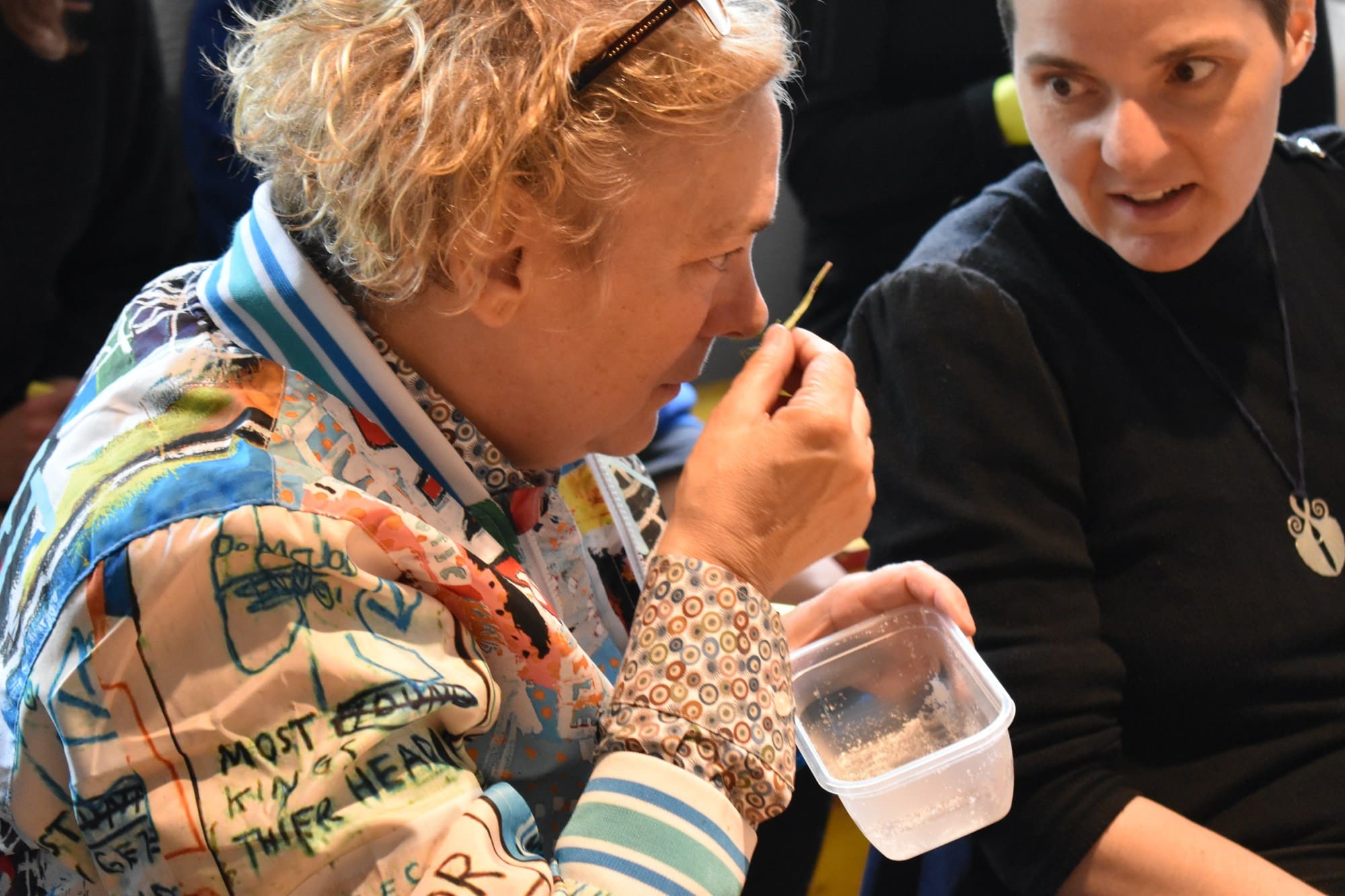 A person smelling an object