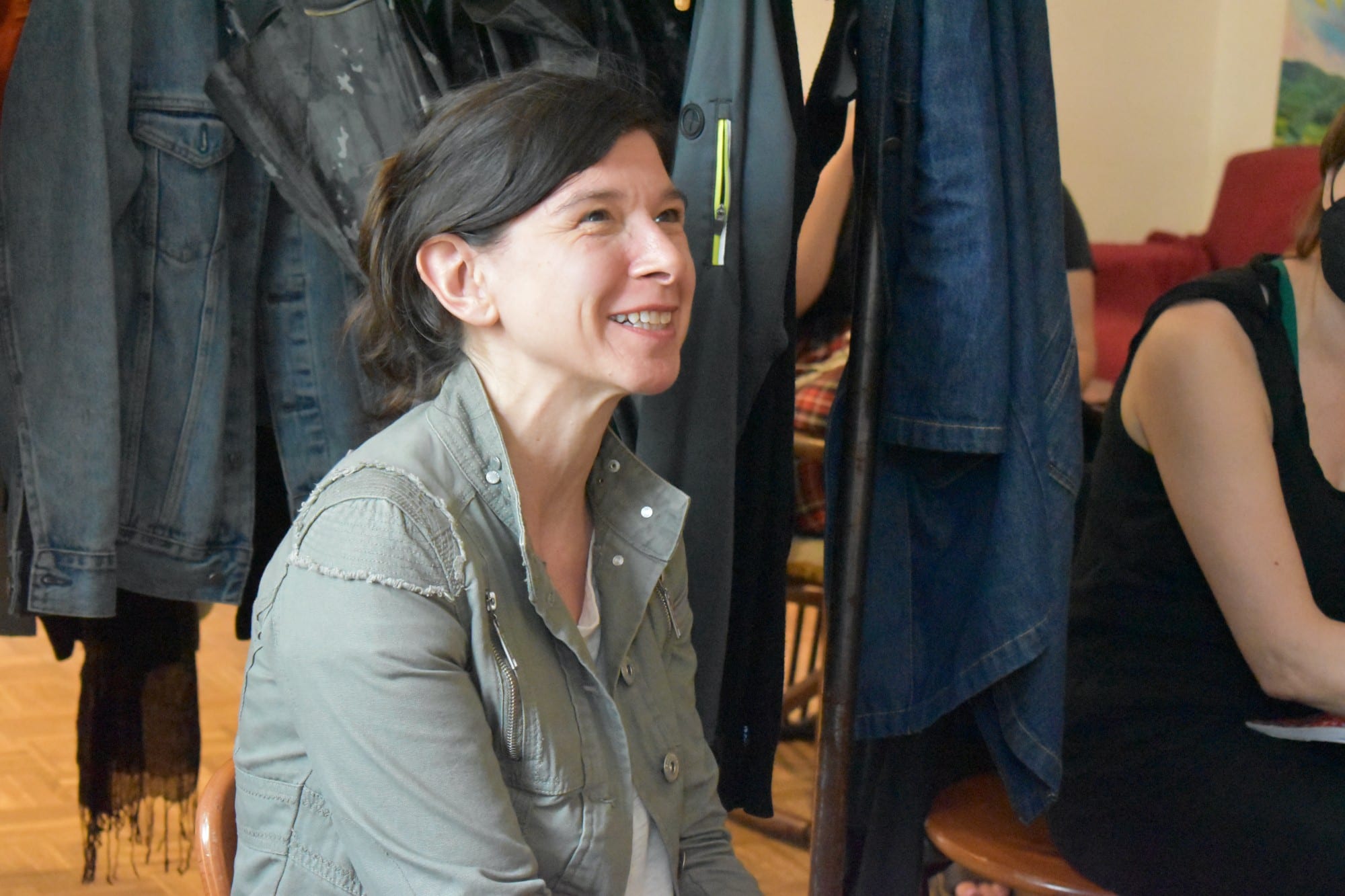 a sitting woman smiles