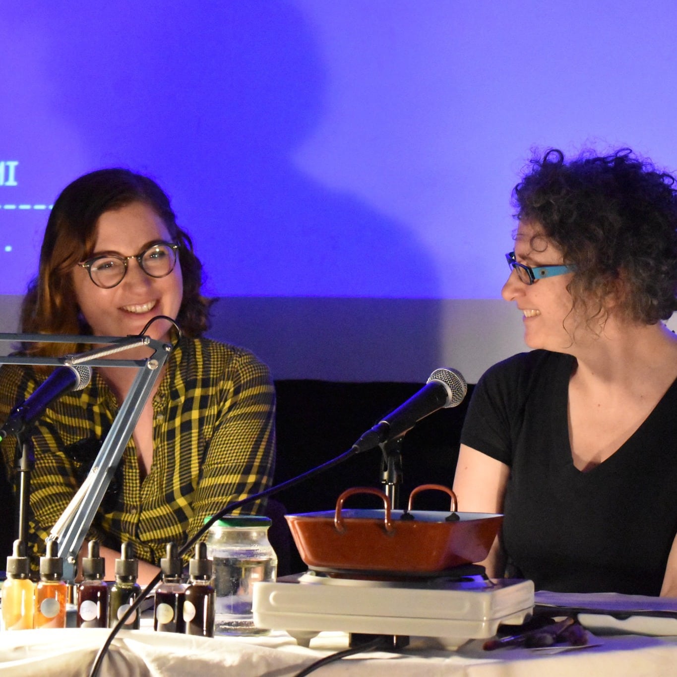 two women seated, smiling