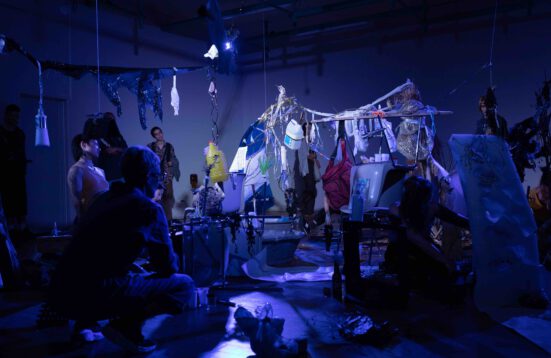 people building an installation of found material. 