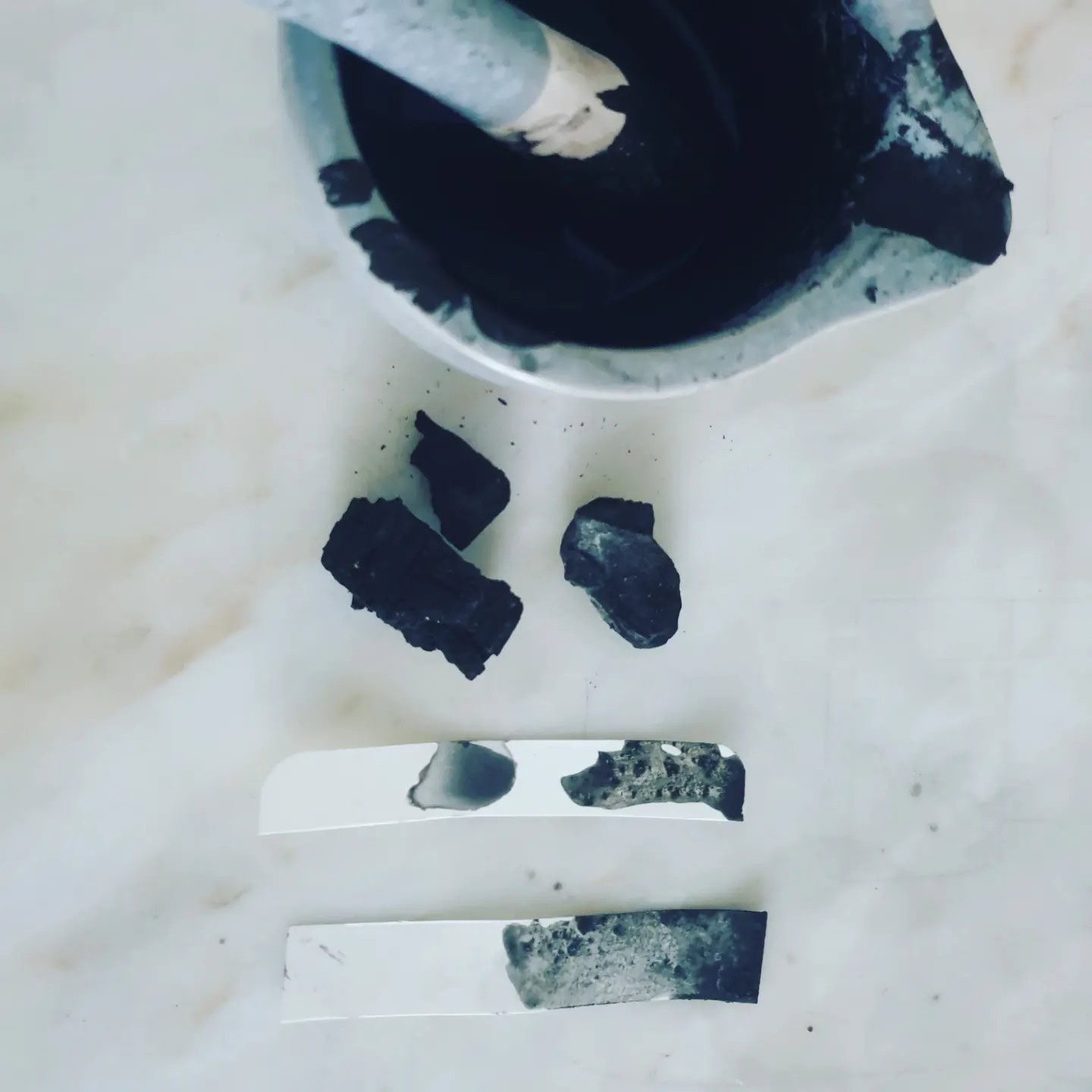 Mortar and pestel containing dark blue ink