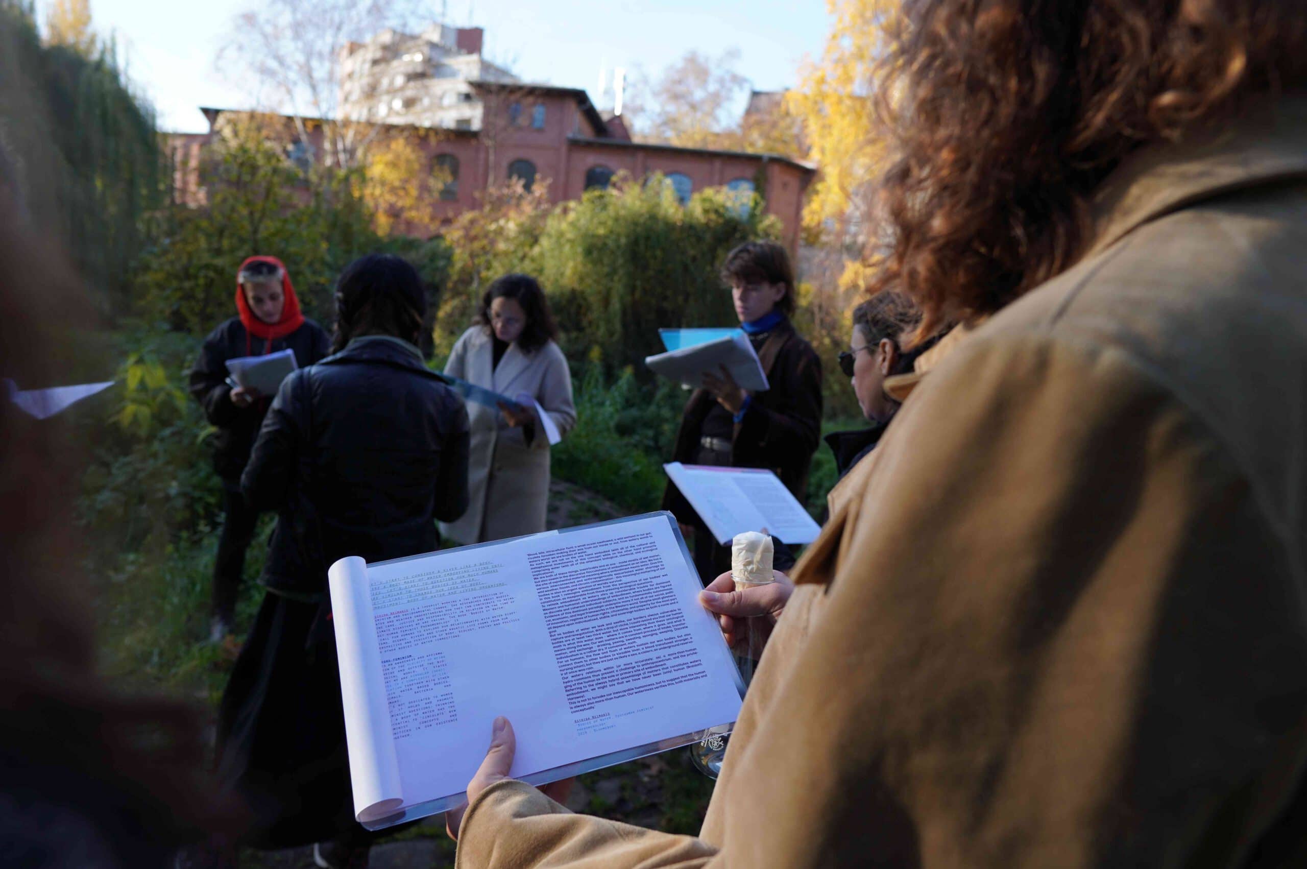 someone looking at a text outside in nature