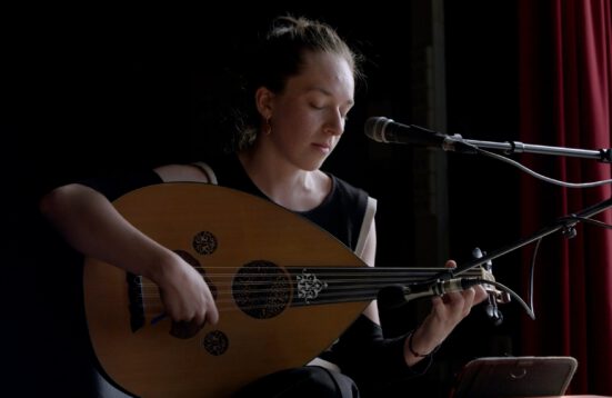 actor playing a lute