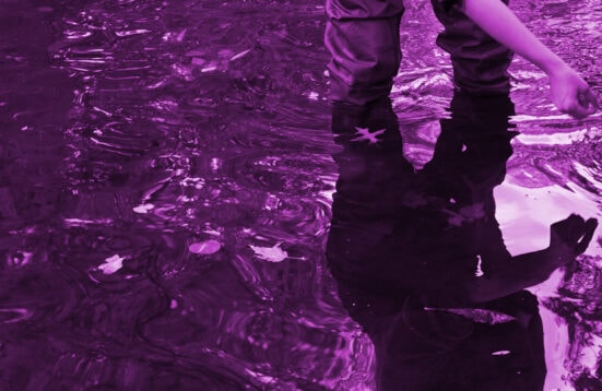 red- violet photograph of a person standing in water
