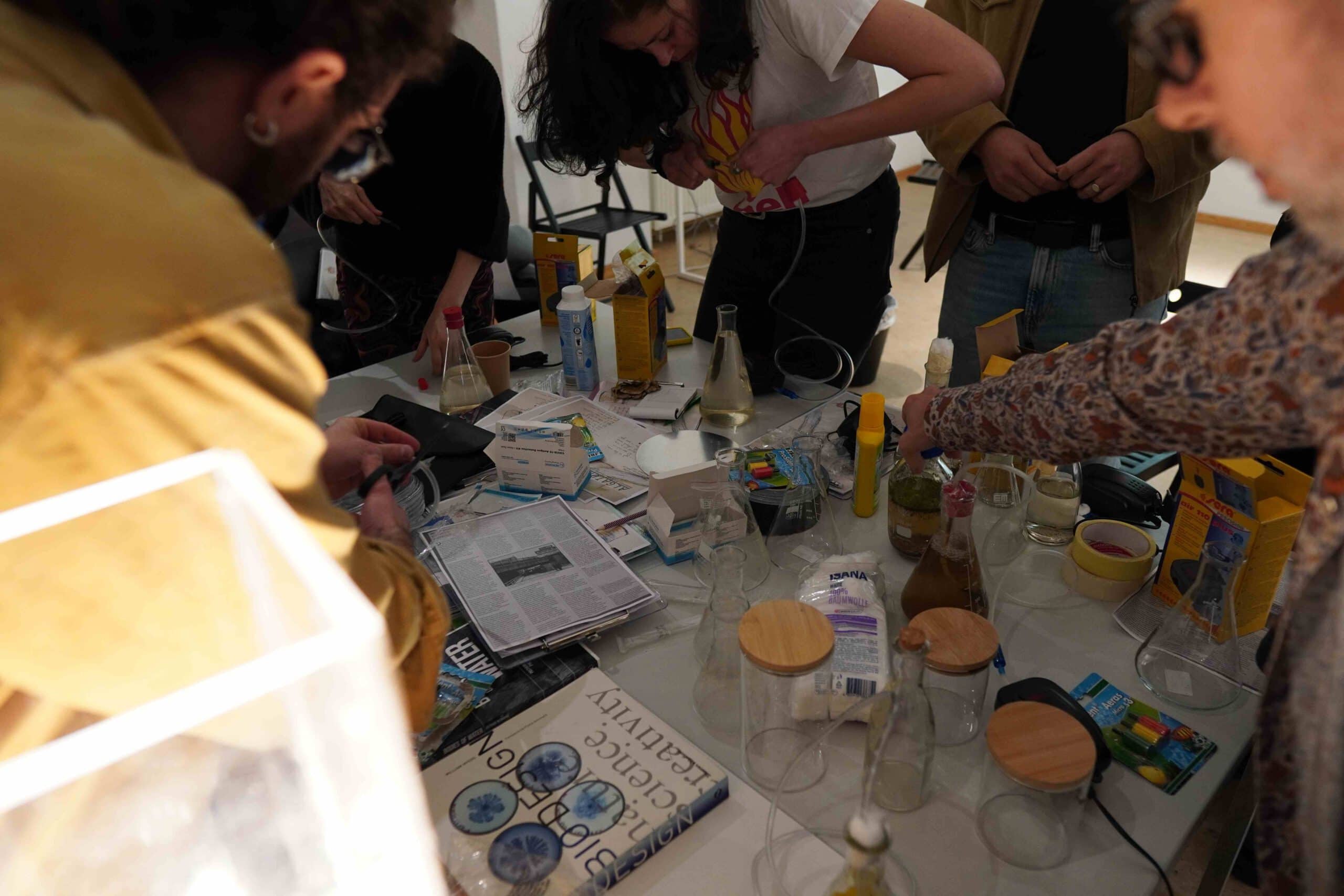 people building something with flasks and tubing